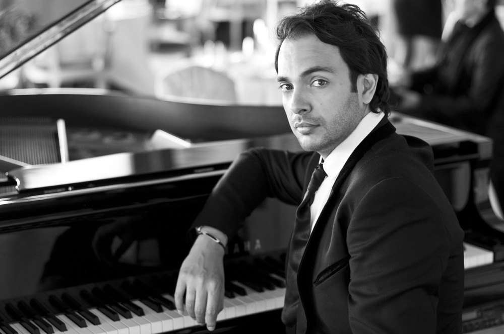 The pianist Christophe Diès sitting at the piano.